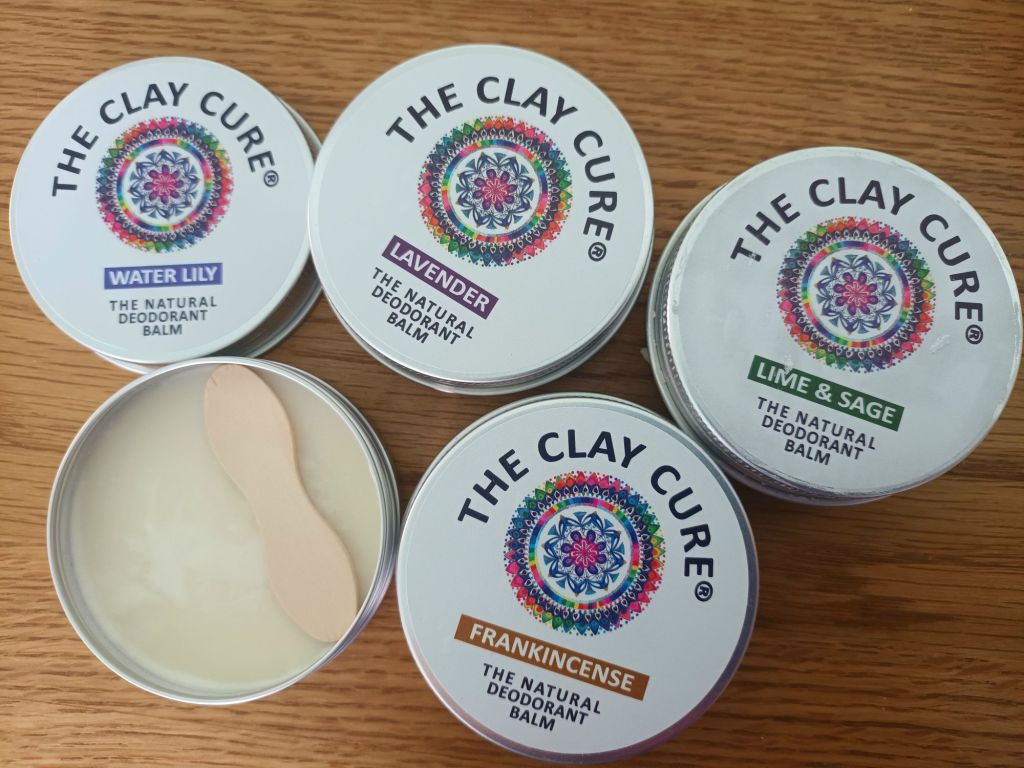 Tins of Clay Cure natural deodorant balm
